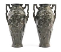 A pair of Art Nouveau pewter vases, in the manner of WMF, with angular handles, decorated with