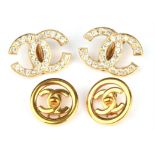 Two pairs of Chanel clip back earrings, one set with central logo motif set in circular boarder,