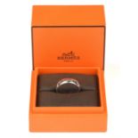 Hermes ring, 'Ever Herakles' design, featuring four 'H' wrapped around the band, stamped 18 ct,