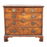 A George I walnut and feather banded chest of drawers, 1720s, the quarter veneered and banded top
