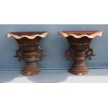 A pair of cast iron floor standing wall planters, of flaring vase form, with leaf form openwork
