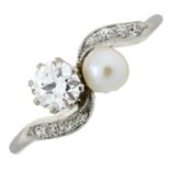 An early 20th century platinum, diamond and pearl crossover ring