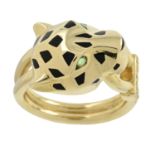 An enamel 'Panthère de Cartier' ring, with onyx nose, garnet eyes and diamond grip, by Cartier