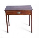 A small George III mahogany side table fitted with a single frieze drawer, oval brass drop handle,