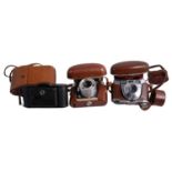 Three vintage cameras, including Voigtlander Bessa and a Voigtlander Dynamic