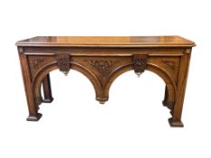 An impressive Gothic revival oak console table with arched apron, width 184cm, depth 59cm, height