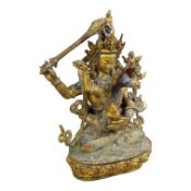 A Sino Tibetan gilt-bronze group of Mahakala and consort, 22cm high