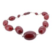 A single strand graduated simulated cherry amber necklace, approx. 42cm, gross weight 51 grams.