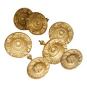 Seven Victorian circular embossed brass curtain tie backs, 17cm diameter
