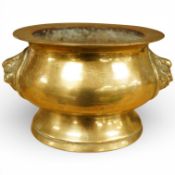 A Chinese bronze censer with mask handles, early 20th century, 13cm diameter.