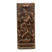 A large Indian carved hardwood relief panel of Krishna, 92cm high