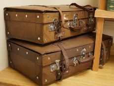 A graduated set of three leather cases with chrome mounts, labelled Golden leaf, with two keys,