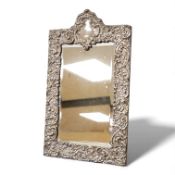 An Edwardian silver mounted easel mirror, Henry Matthews, Birmingham, 1908, 41.8cm by 25.3cm.