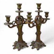 A pair of French Art Nouveau patinated and green-painted spelter candelabra, 40cm high