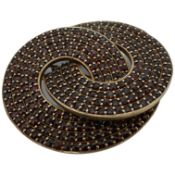 A garnet brooch, designed as two interlocking hoops, set with rose-cut diamonds, mounted in