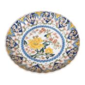 An Dutch Delft wallplate, polychrome painted with birds and foliage, 27.5cm diameter