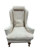 A Queen Anne Revival upholstered wingback armchair, width 92cm, depth 76cm, height 120cm