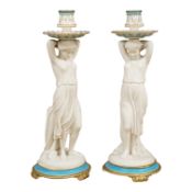 A pair of Victorian glazed and bisque porcelain figural candlesticks, 34cm high