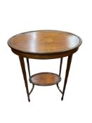 An Edwardian marquetry inlaid mahogany oval two tier occasional table, in the manner of Edwards &