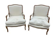A pair of Louis XVI style upholstered walnut open armchairs, width 68cm, depth 62cm, height 94cm