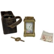A miniature brass carriage timepiece, enamel dial and panels, with key, in leather case, timepiece