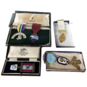 A Masonic silver-gilt and enamel medal, and four other civilian medals, Masonic medal 13cm overall