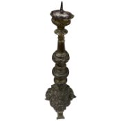 A 17th century Italian embossed brass pricket candlestick, 53cm high overall