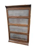 A four section Globe Wernicke style oak bookcase, width 87cm, depth 30cm, height 145cm