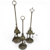 A group of three Lucerna style brass oil lamps. Tallest 59cm