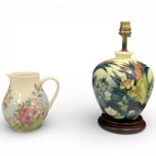 A Moorcroft lamp base in the Lamia pattern and a Moorcroft jug, spring blossom pattern, both boxed