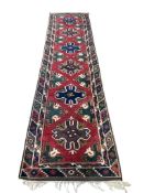 A Caucasian red ground runner, 327 x 82cm