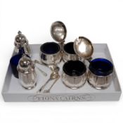An early 1950's six piece silver condiment set, with four matching spoons and blue glass liners by