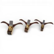 A set of three 'winged' brass thumb planes with wood infills and flat soles, widest iron 19mm
