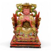 A Chinese gilt and painted composition figure of a seated immortal, 31cm tall