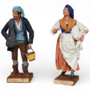 A pair of Neapolitan terracotta and composition peasant figures, 33cm, now on ebonised stands