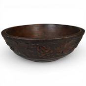 A Victorian beech mixing bowl, carved with grapes and vine leaves, 28cm in diameter