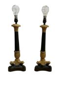 A pair of Empire style ormolu and patinated bronze column table lamps with paw feet, 47cm high