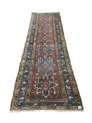 A Heriz red ground runner, 300 x 92cm