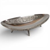 A 20th century Indian white metal oval dish, stamped 'sterling silver', and decorated elephants