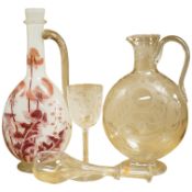 A Continental Art Nouveau glass carafe enamelled with flowers, an English wine glass engraved with