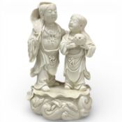 A Chinese blanc de chine group of Hehe Erxian, 24cm high