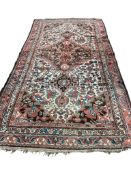 An antique Baktiari ivory ground carpet, 330 x 162cm