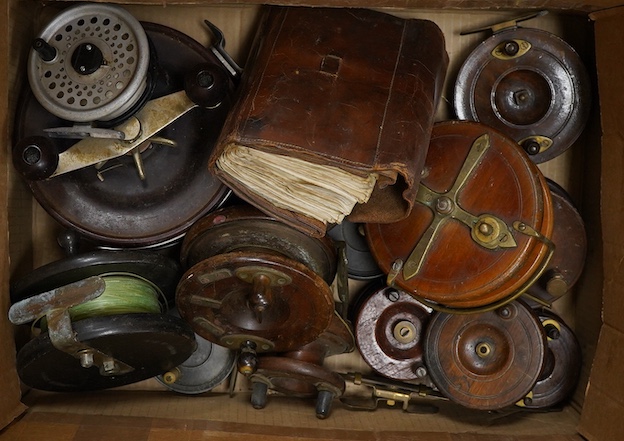 A collection of vintage fishing reels, including mahogany and brass examples one with patent