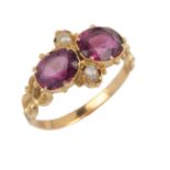 An early Victorian garnet and seed pearl ring, mid 19th century, set with two oval garnets and two