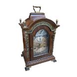 A Warmink mahogany bracket clock, the arched case with gilt metal mounts and finials, the brass dial