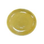 A Chinese porcelain yellow glazed ‘dragon’ dish, 26cm in diameter