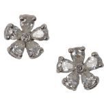 A pair of diamond stud earrings, designed as floral arrangements of pear-shaped diamonds around a