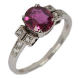 A ruby ring, claw-set with an oval ruby weighing 1.28 carats, to shoulders claw-set with brilliant-