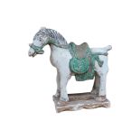 A Chinese part glazed pottery model of a horse, probably Ming dynasty, 26cm high