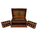 A Victorian mahogany cased games compendium, including a chess set, cribbage board, dominoes,